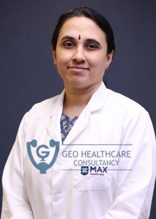 Female doctor in a white coat over traditional dress, smiling
